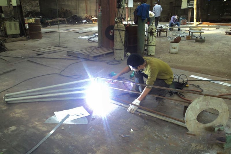 Welding the Pieces of Stainless Steel Sculpture Together